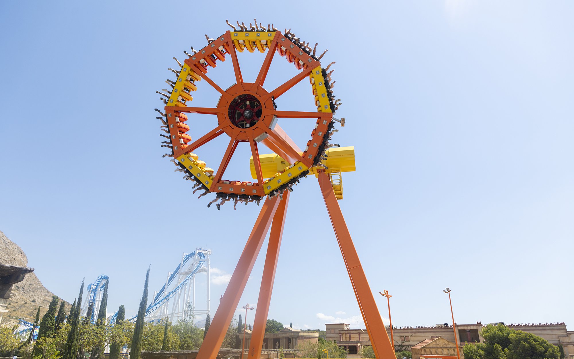 Amusement ride at Terra Mitica Benidorm with roller coaster in background.