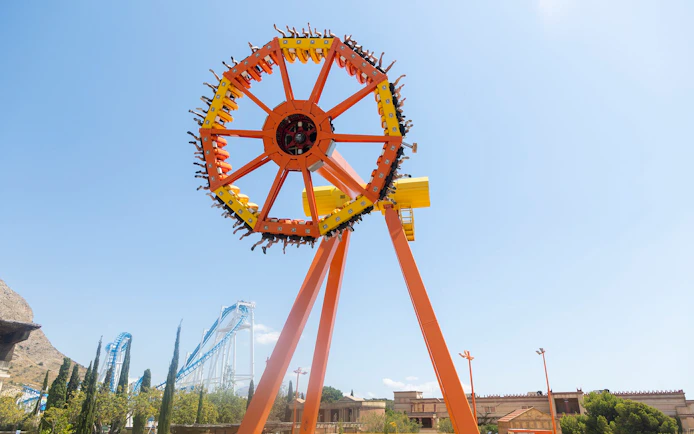 Amusement ride at Terra Mitica Benidorm with roller coaster in background.