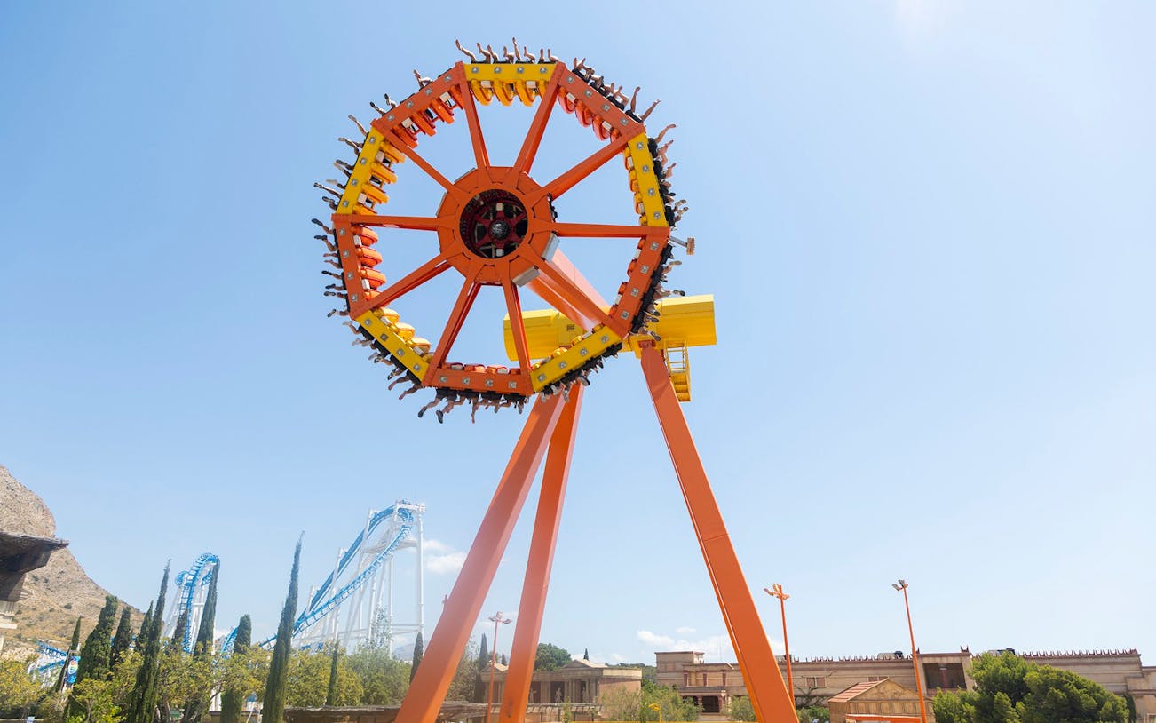 Amusement ride at Terra Mitica Benidorm with roller coaster in background.