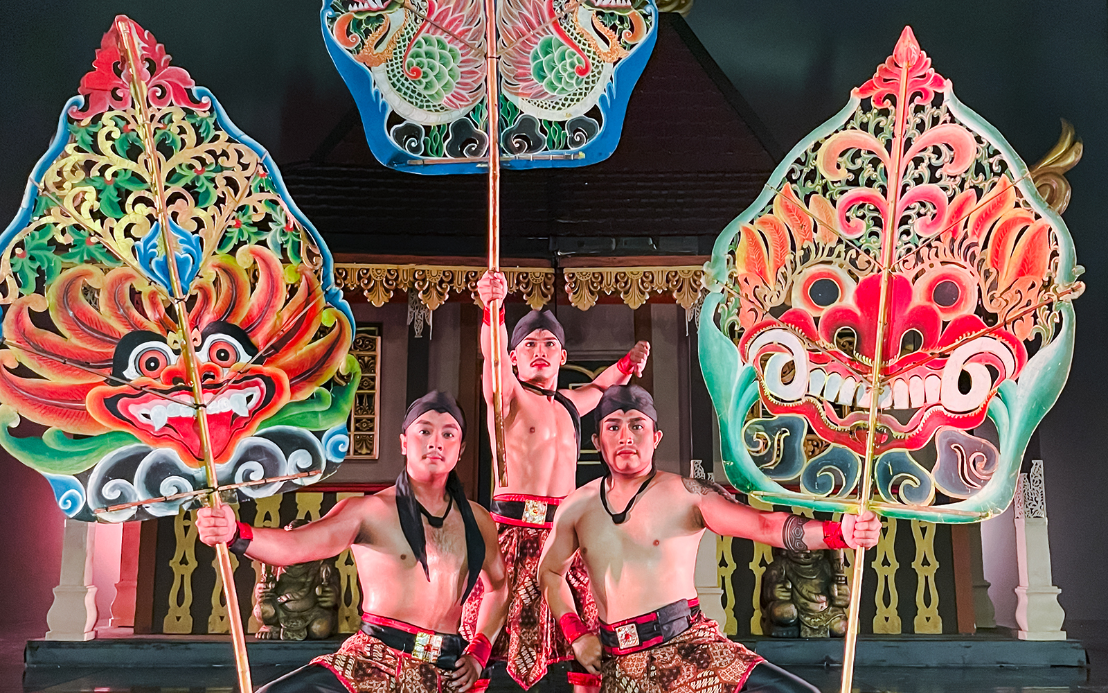 Performers holding ornate shields during the Devdan Show in Bali, showcasing cultural artistry.