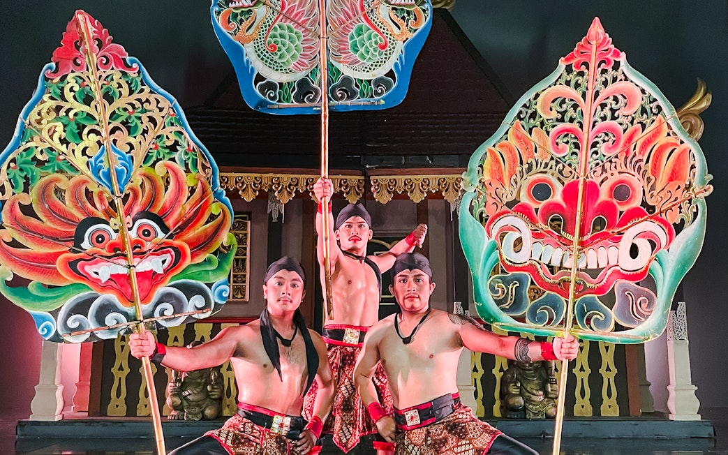 Performers holding ornate shields during the Devdan Show in Bali, showcasing cultural artistry.