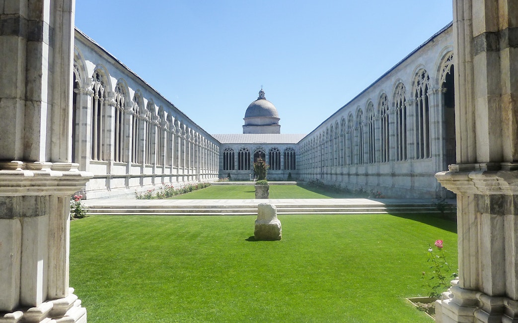 Pisa Baptistery and Cathedral courtyard with arches and central dome.