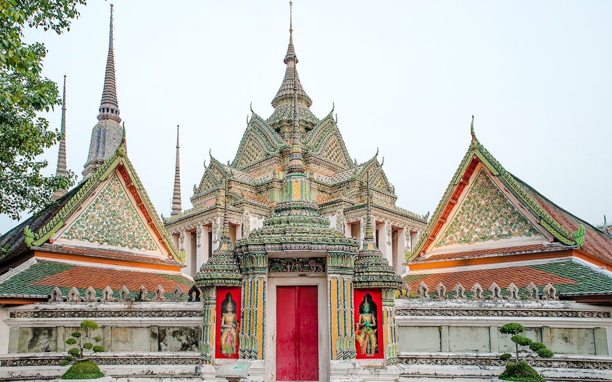 Wat Pho temple complex with ornate spires and intricate carvings, Bangkok, Thailand.