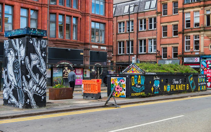 Street art and historic buildings in Manchester city center during a self-guided exploration game.