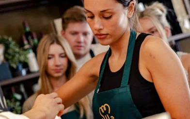 Participants in a pasta and tiramisu cooking class during a Florence walking tour.