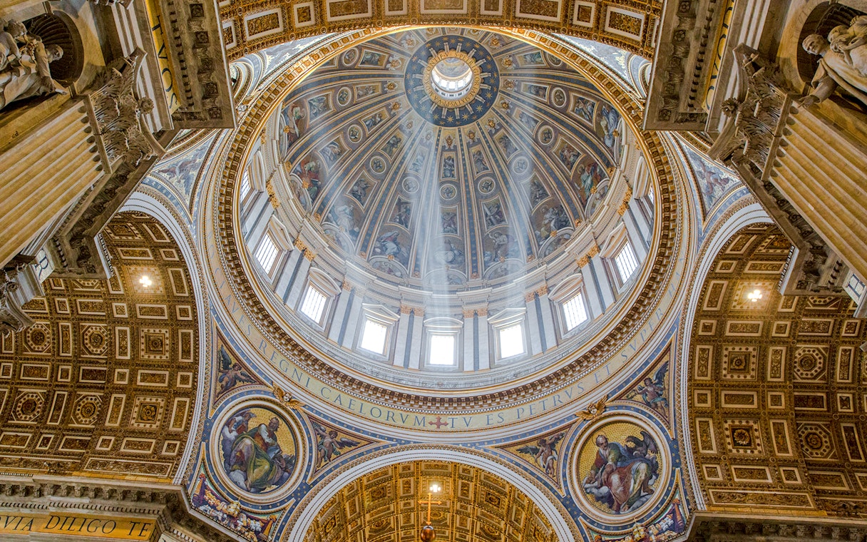 Interior view of St. Peter’s Basilica dome with intricate artwork, Vatican City.