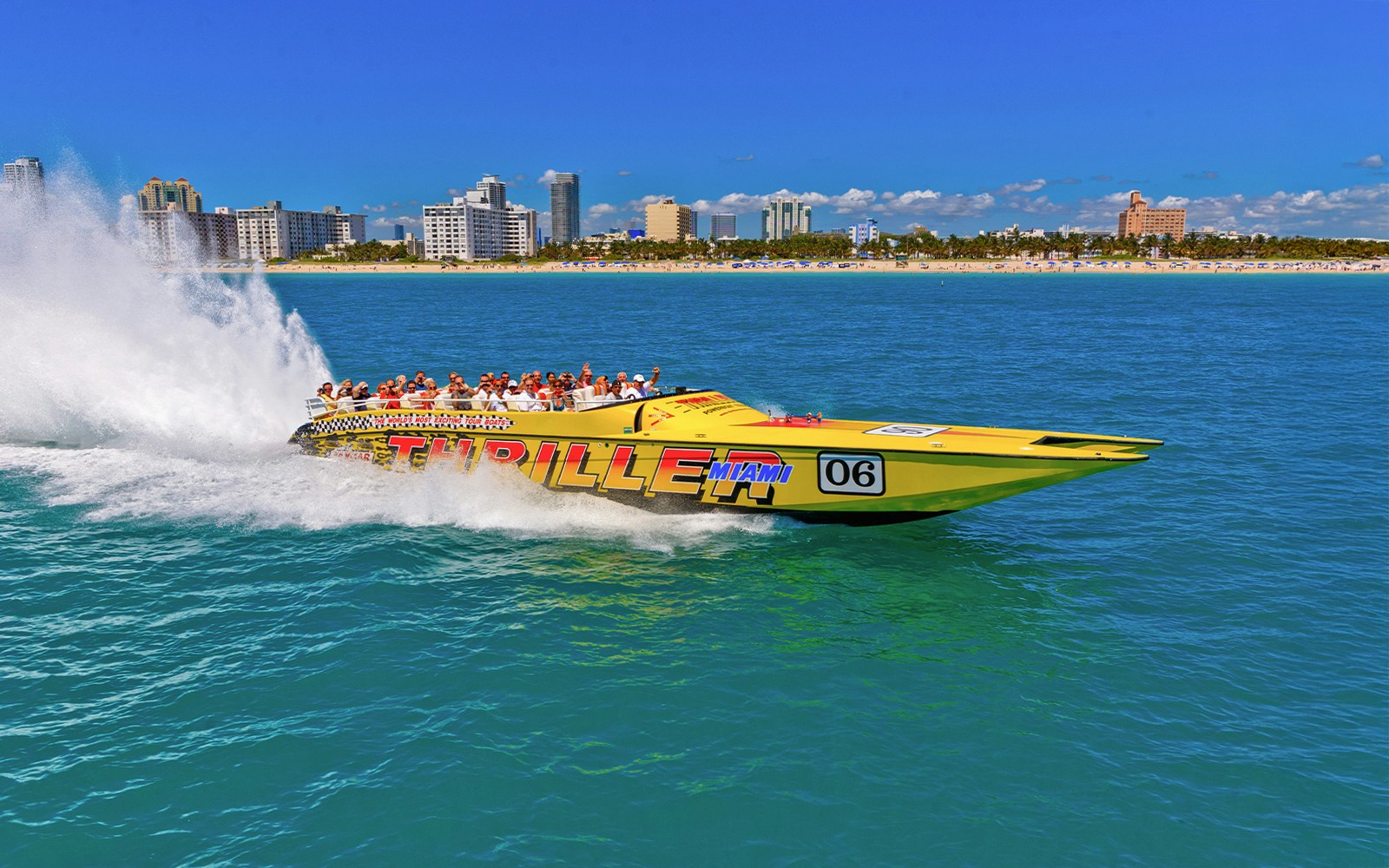 Speedboat on Miami waters with city skyline in the background.
