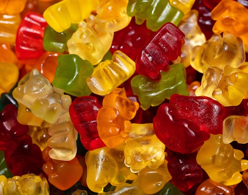 Honey Bear jelly candies in a colorful assortment on display in a candy shop.