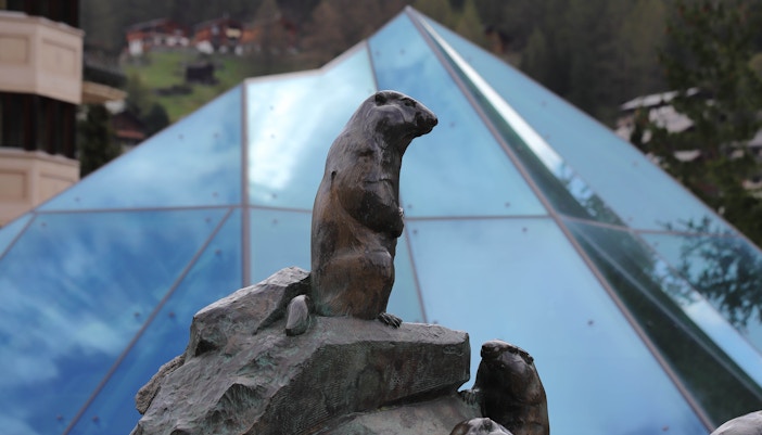 Marmot statue in front of the Matterhorn Museum's glass pyramid in Zermatt, Switzerland.