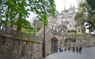 Quinta da Regaleira entrance with tourists in Sintra, Portugal.