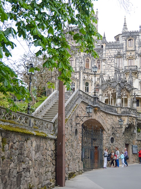 Quinta da Regaleira entrance with tourists in Sintra, Portugal.