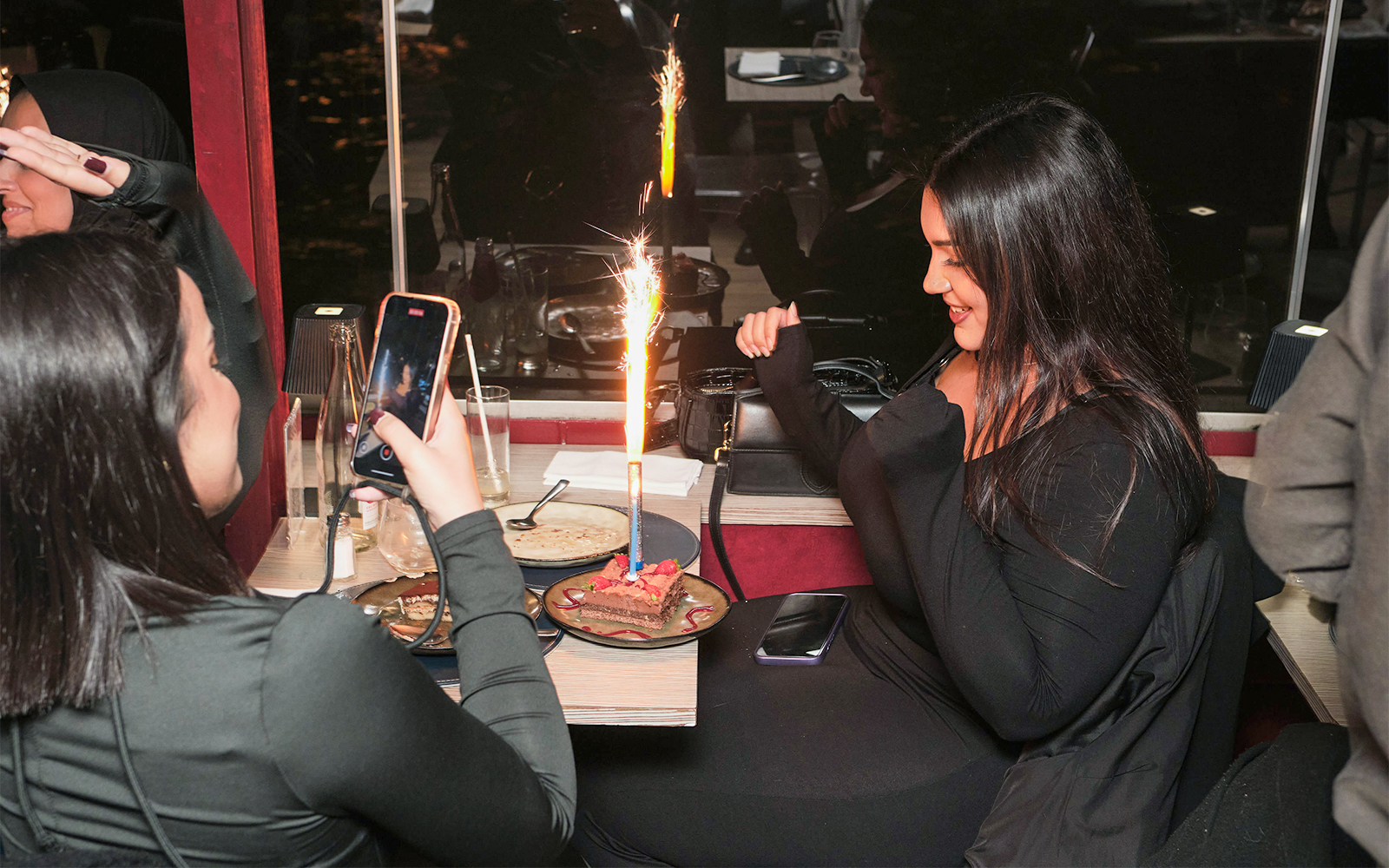 Guests enjoying dessert with sparklers on Théo Boat Seine River Dinner Cruise.