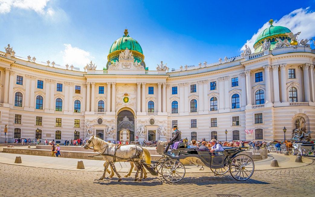 Horse-drawn carriage in front of Hofburg Palace, Vienna, Austria.