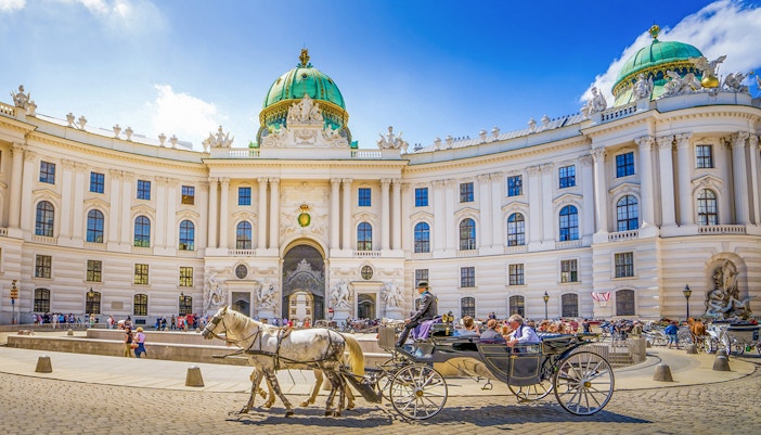 Horse-drawn carriage in front of Hofburg Palace, Vienna, Austria.