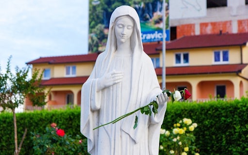 Statue of the Queen of Peace holding a rose near Saint James Church, Medjugorje.