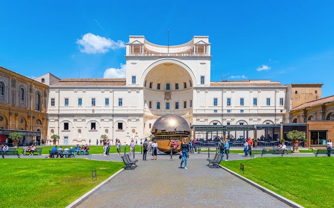 Courtyard of the Pigna in Vatican Museums with bronze sphere sculpture.