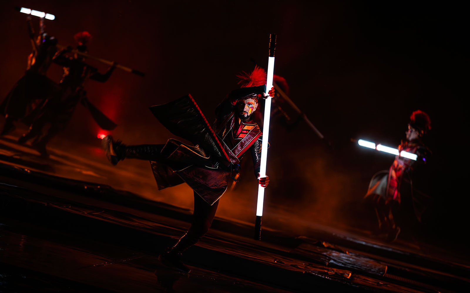 Performers with illuminated staffs in the Kiss of the Sea Show.