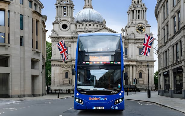 Open-top London tour bus in front of St. Paul's Cathedral.