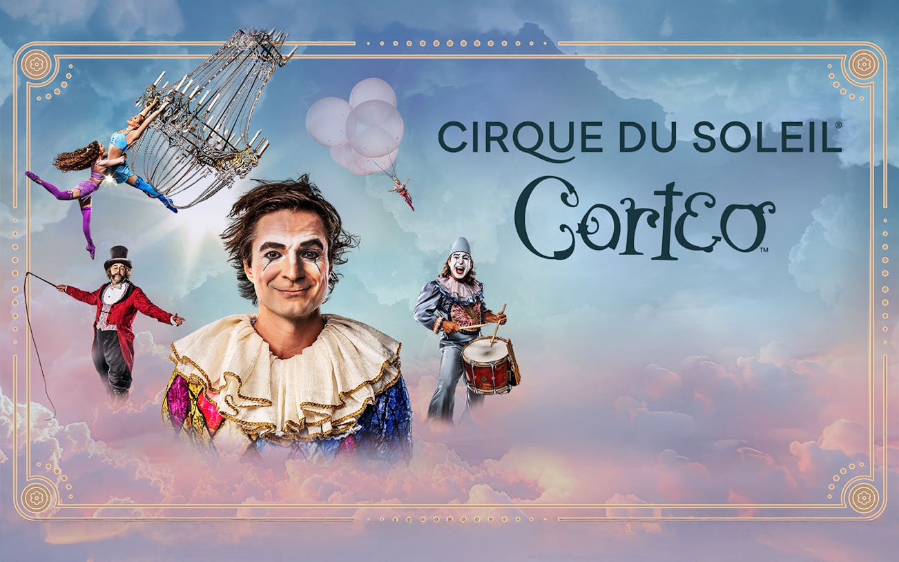 Performers in colorful costumes from Cirque du Soleil: Corteo with a chandelier and drum.