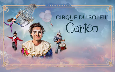 Performers in colorful costumes from Cirque du Soleil: Corteo with a chandelier and drum.