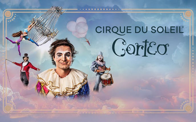 Performers in colorful costumes from Cirque du Soleil: Corteo with a chandelier and drum.