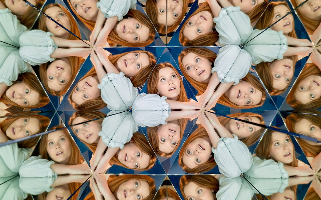 Person reflected multiple times in mirrors at Museum of Illusions Dubai.