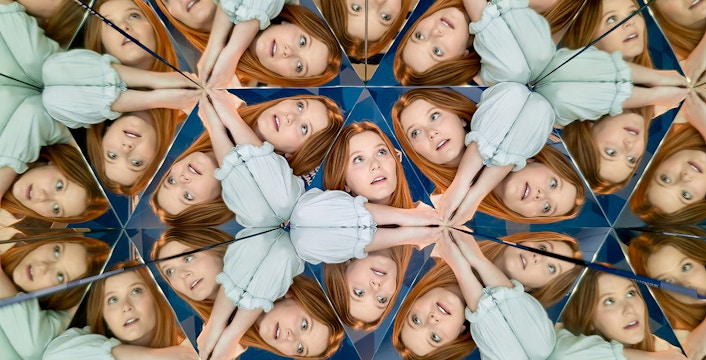 Person reflected multiple times in mirrors at Museum of Illusions Dubai.
