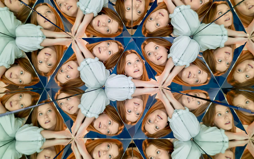 Person reflected multiple times in mirrors at Museum of Illusions Dubai.