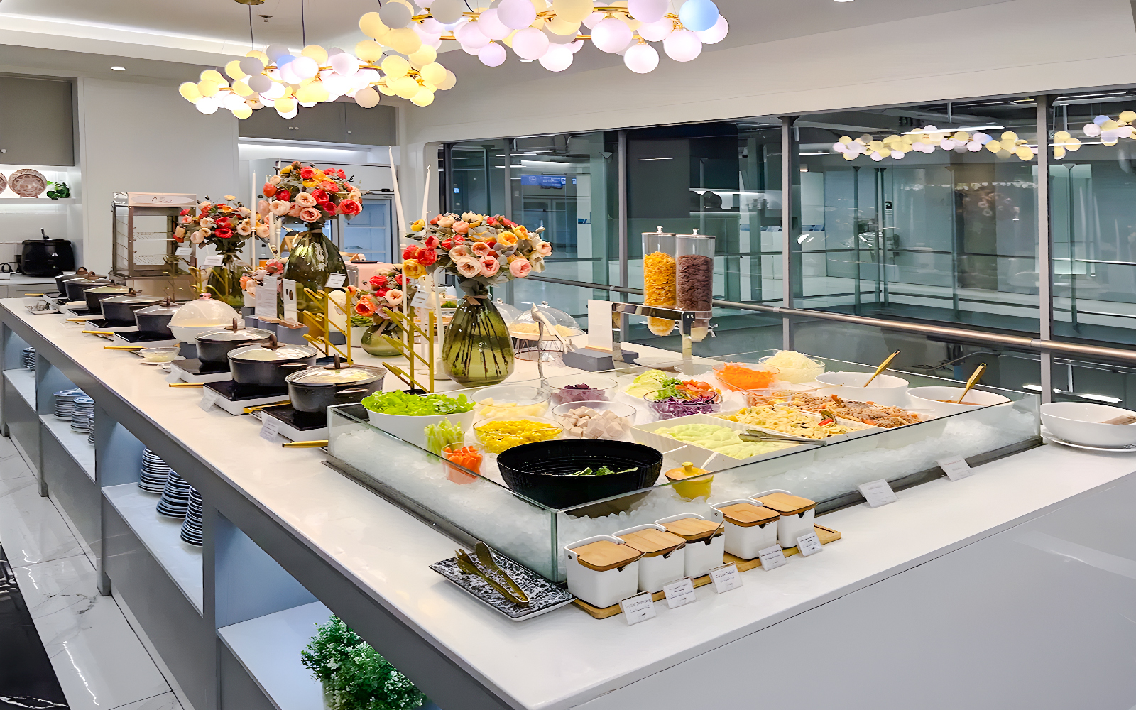 Buffet spread at Coral Finest Business Class Lounge, Bangkok airport, featuring salads and hot dishes.