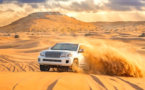 4x4 vehicle dune bashing in the Dubai desert.