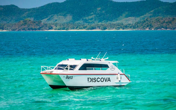 Speedboat on turquoise waters near Phang Nga, Thailand, for James Bond Island tour.