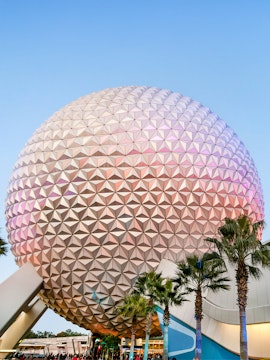 Spaceship Earth at EPCOT Center, Walt Disney Resort Orlando, with palm trees in foreground.