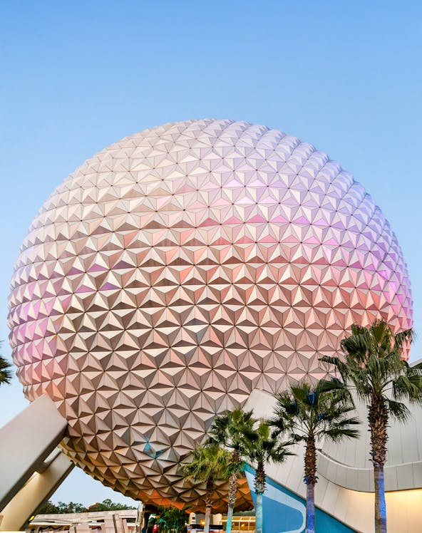 Spaceship Earth at EPCOT Center, Walt Disney Resort Orlando, with palm trees in foreground.