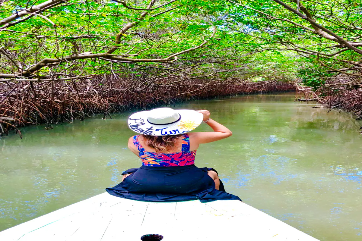 Woman on boat in Icaraí de Amontada mangrove tunnel, Sao Paulo.