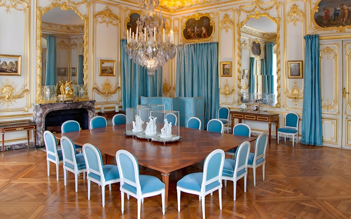 Versailles King's Private Apartment Porcelain Dining Room with ornate decor and blue chairs.