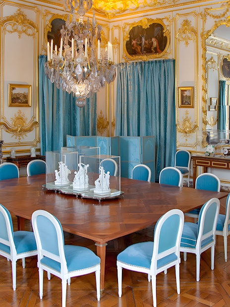 Versailles King's Private Apartment Porcelain Dining Room with ornate decor and blue chairs.
