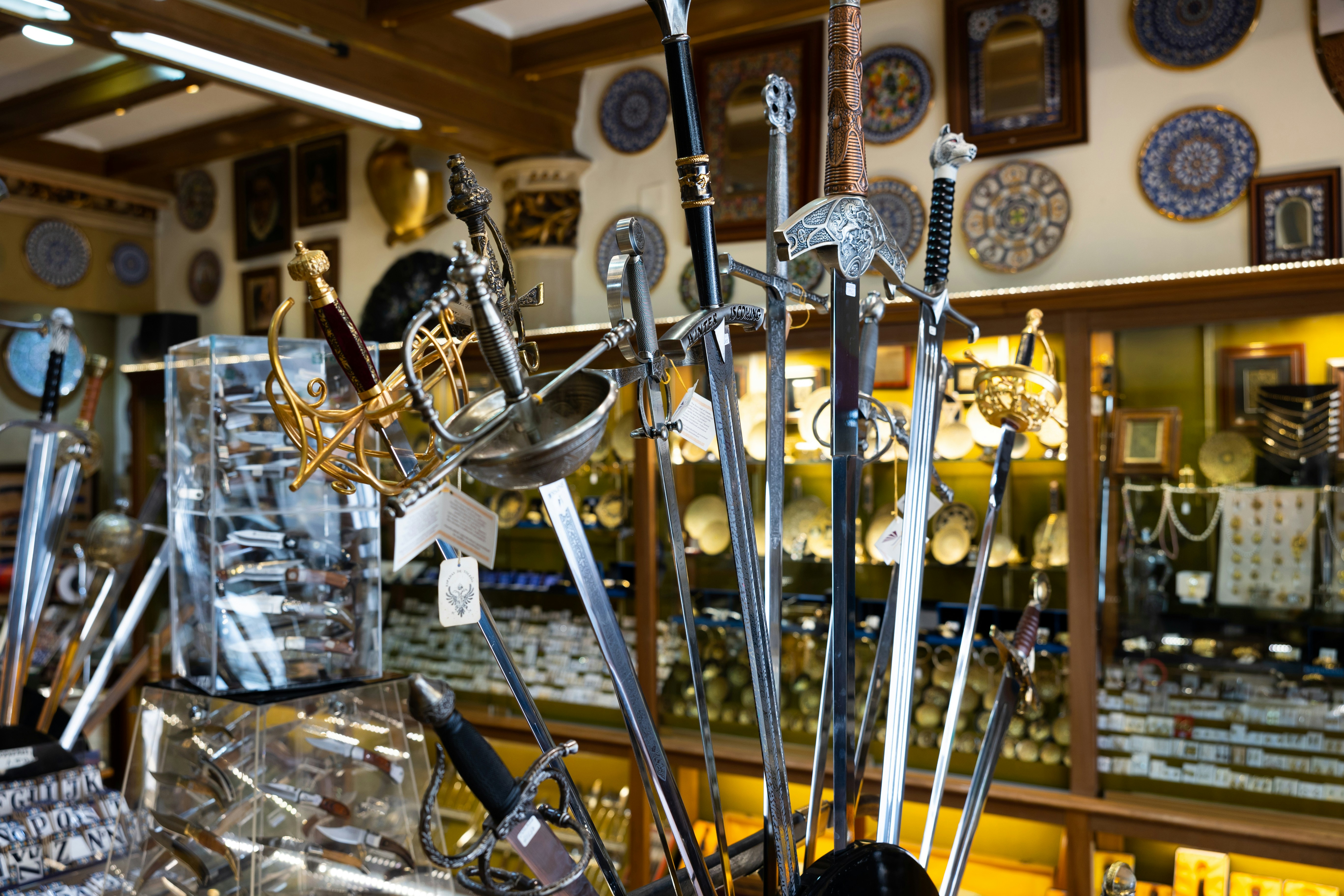 Collection of old-fashioned swords displayed in a Toledo souvenir shop.