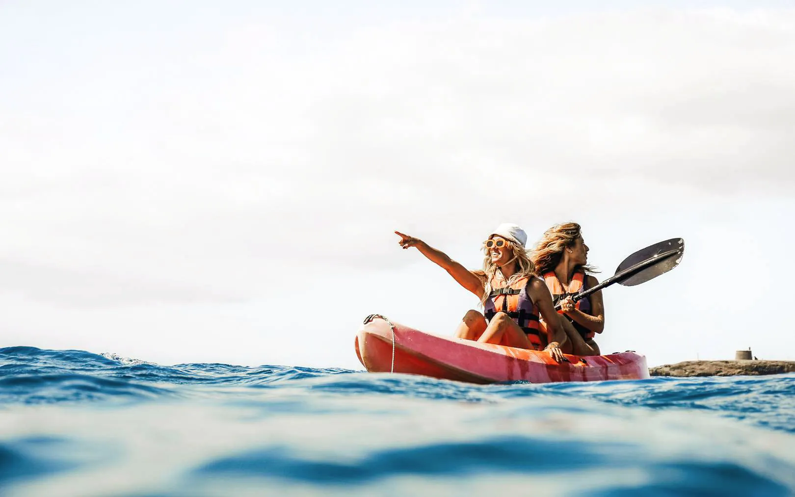 Kayaking near Papagayo Beaches, Lanzarote, with two people in a red kayak.