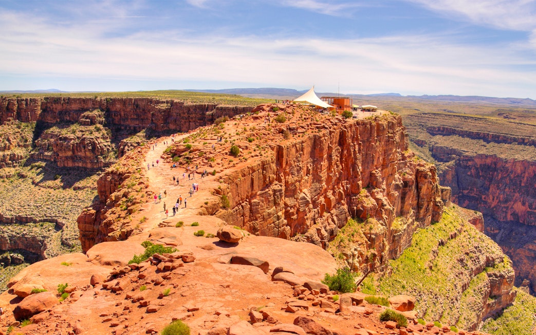 Visitors walking along the rocky path at Guano Point, Grand Canyon West Rim.