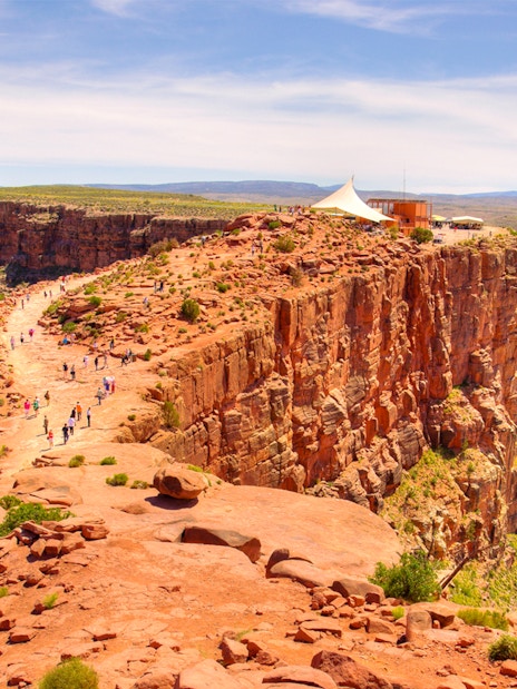 Visitors walking along the rocky path at Guano Point, Grand Canyon West Rim.