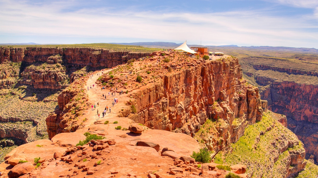 Visitors walking along the rocky path at Guano Point, Grand Canyon West Rim.