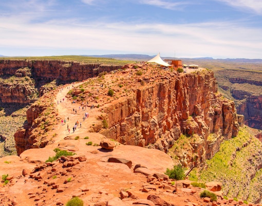 Visitors walking along the rocky path at Guano Point, Grand Canyon West Rim.