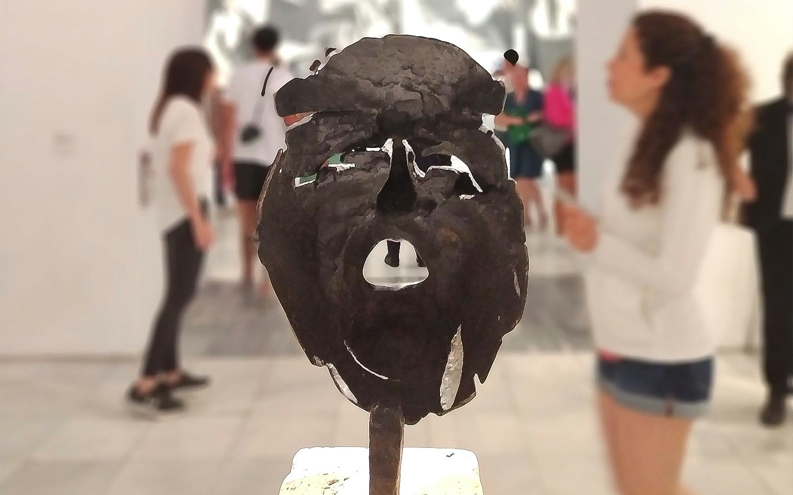 Tourists viewing a sculpture at the Reina Sofia Museum in Madrid.