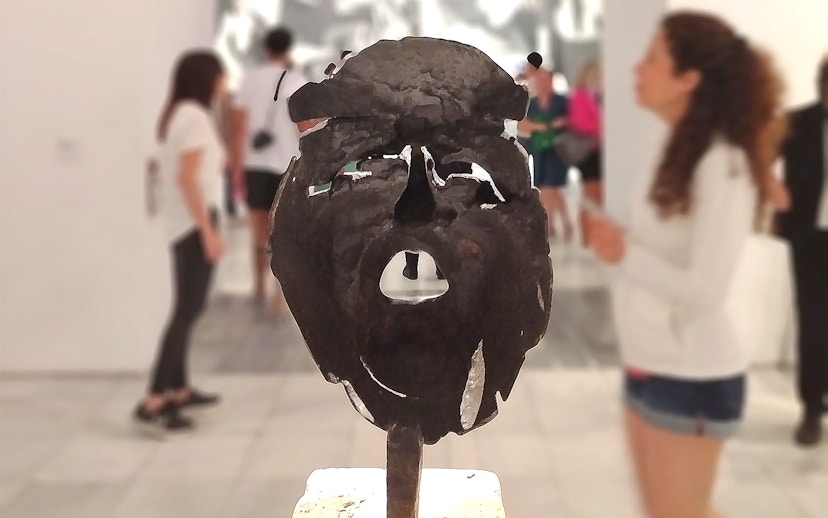 Tourists viewing a sculpture at the Reina Sofia Museum in Madrid.