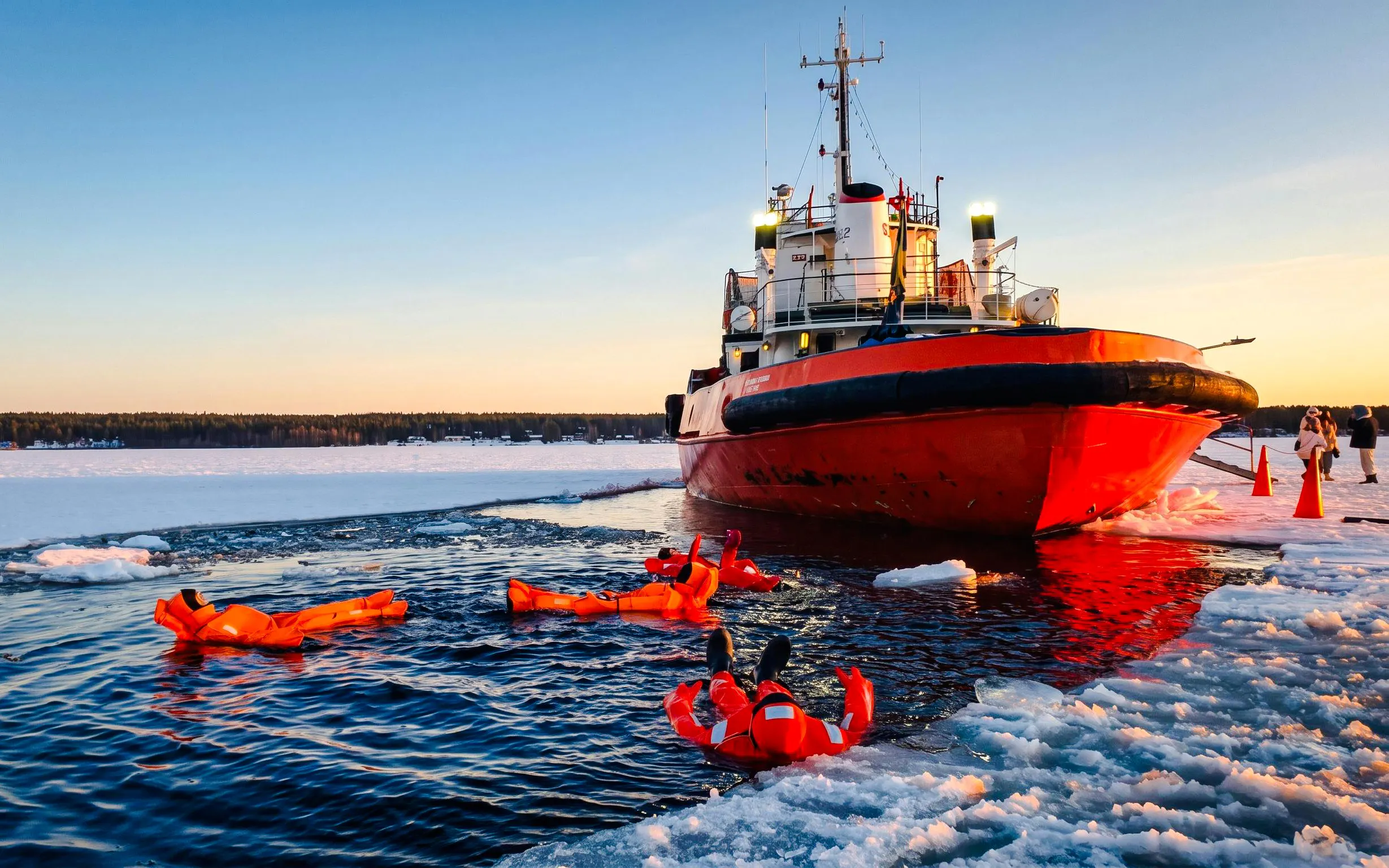 Icebreaker cruise with people floating in icy water during Icebreaker Cruise & Ice Floating Experience.