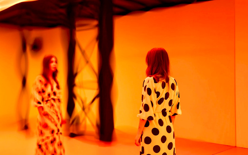 Guest viewing light installation at Light Art Museum exhibit.