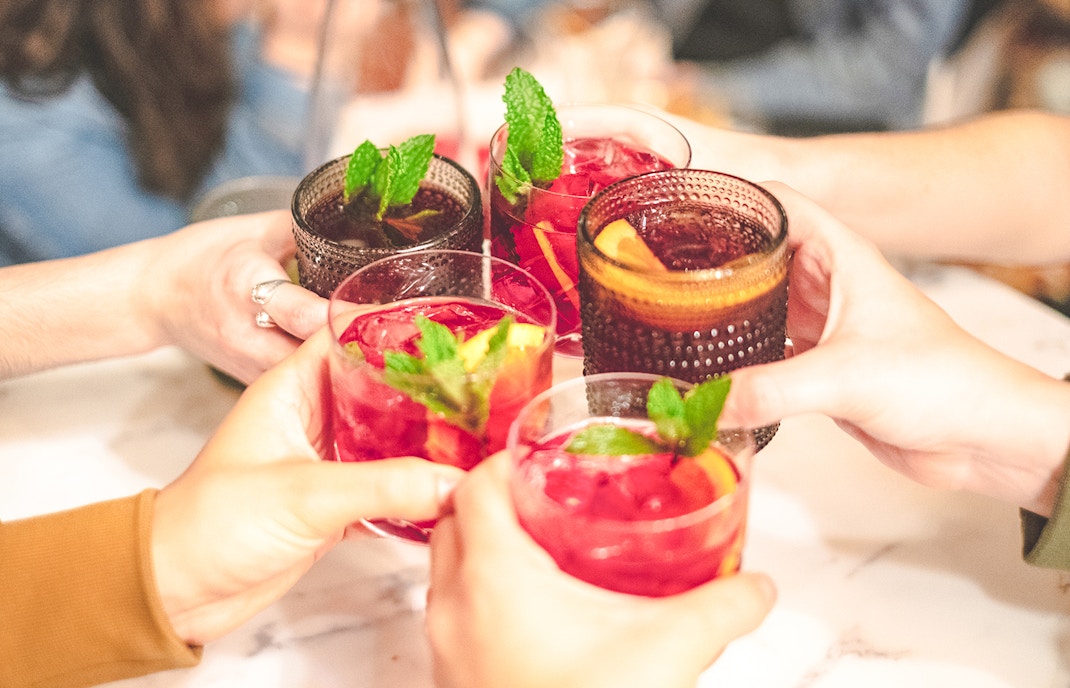 Cheers with sangria glasses at Montjuïc restaurant.