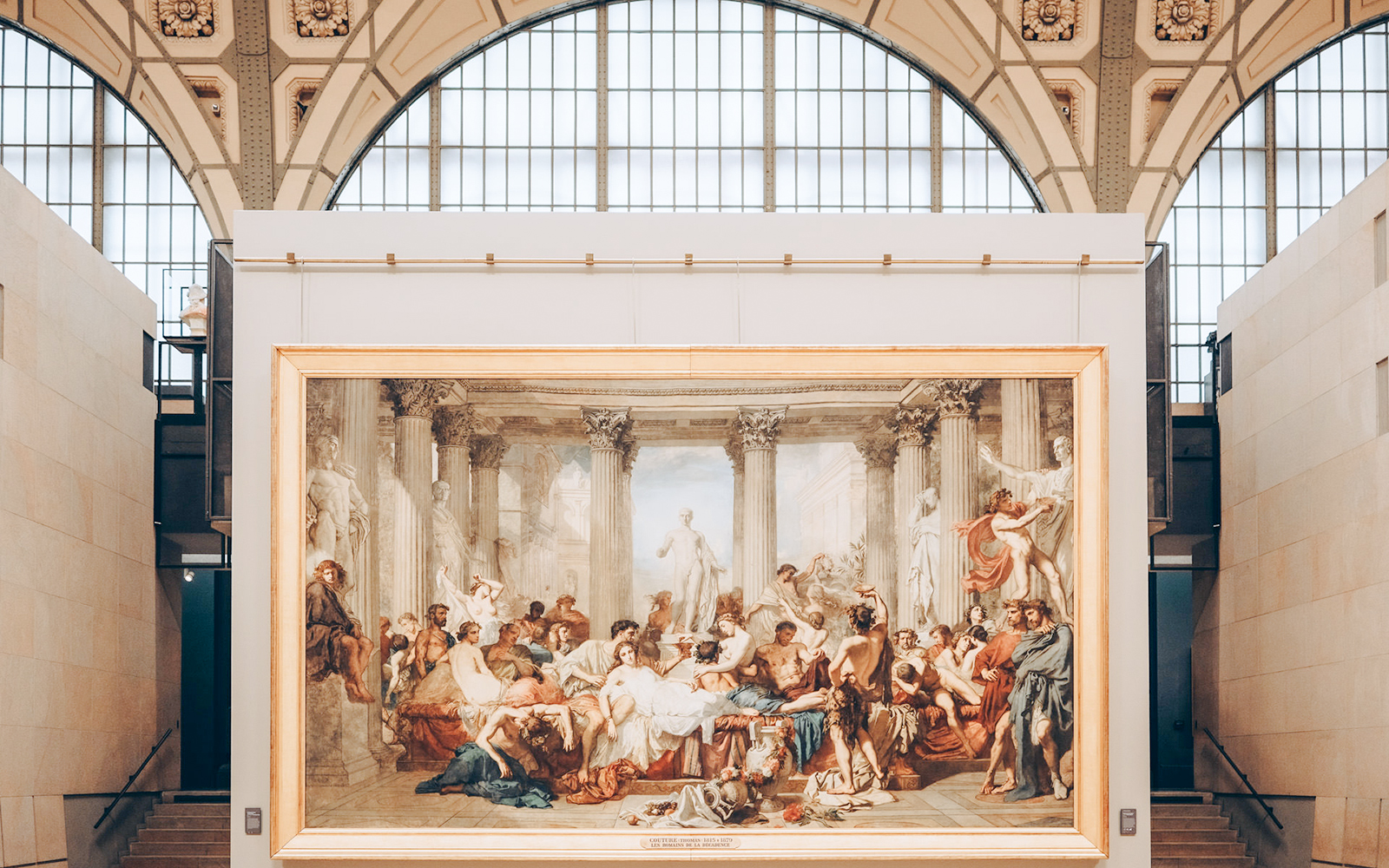 Painting of classical scene with figures and columns inside Orsay Museum, Paris.
