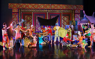 Performers in traditional costumes at the Devdan Show in Bali, depicting Indonesian culture.