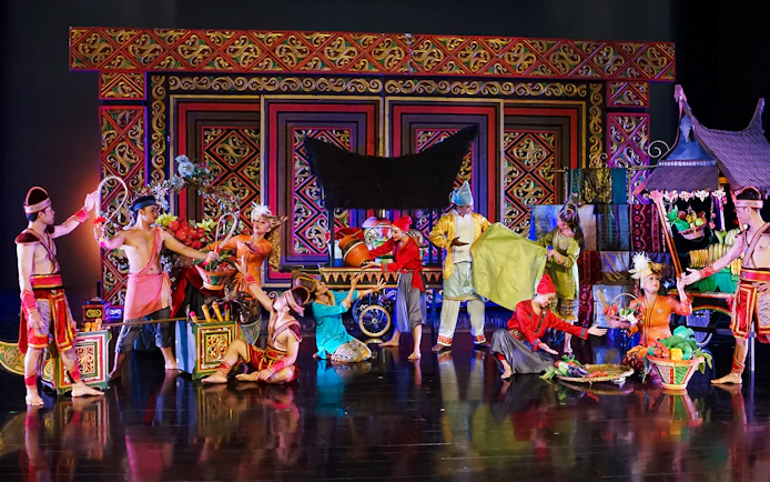 Performers in traditional costumes at the Devdan Show in Bali, depicting Indonesian culture.